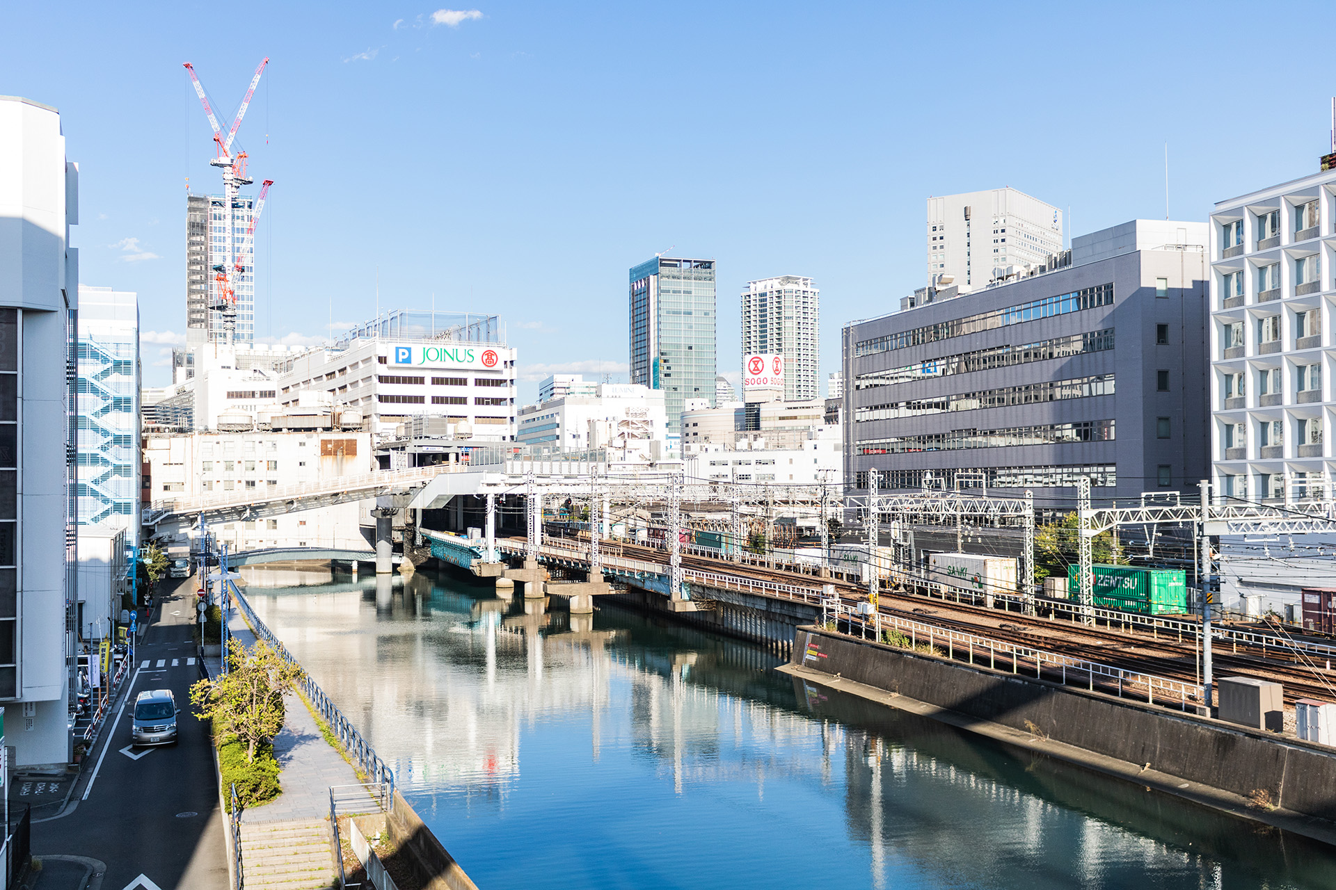 Canal with bright modern buildings surrounding it.